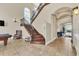 Impressive, curved staircase with ornate railing in a large foyer at 364 Muirfield Loop, Reunion, FL 34747