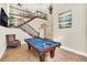 Game room featuring a pool table, high ceilings, and a view of the upper level at 364 Muirfield Loop, Reunion, FL 34747