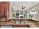 Kitchen features granite countertops, a double sink, and views into the Gathering room at 364 Muirfield Loop, Reunion, FL 34747