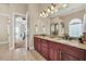 Double vanity bathroom with granite countertops and access to the bedroom at 364 Muirfield Loop, Reunion, FL 34747