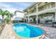 Stunning pool and spa with patio and two-story home in background at 364 Muirfield Loop, Reunion, FL 34747