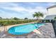 Inviting kidney-shaped pool with spa and lounge chairs; golf course view at 364 Muirfield Loop, Reunion, FL 34747
