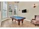 Spacious game room with a pool table and comfortable seating at 364 Muirfield Loop, Reunion, FL 34747