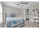 Bedroom with gray upholstered bed, dresser, and access to bathroom at 1409 Sutton Island Dr, Deland, FL 32724