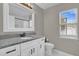 Bathroom with granite countertop, white cabinets, and subway tile at 1409 Sutton Island Dr, Deland, FL 32724