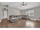 Spacious living room with L-shaped sofa and wood flooring at 1409 Sutton Island Dr, Deland, FL 32724