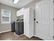 Laundry room with washer, dryer, and built-in cabinets at 1409 Sutton Island Dr, Deland, FL 32724