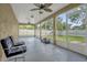Spacious screened patio with lawn mower and seating at 1409 Sutton Island Dr, Deland, FL 32724