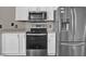Kitchen with stainless steel appliances and white cabinets at 1409 Sutton Island Dr, Deland, FL 32724