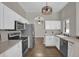 Open kitchen with stainless steel appliances and white cabinets at 1409 Sutton Island Dr, Deland, FL 32724