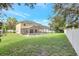 Large backyard with a screened pool and grassy area at 5010 Cawthon Way, Saint Cloud, FL 34771