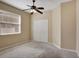 Spacious bedroom with ceiling fan and large window at 5010 Cawthon Way, Saint Cloud, FL 34771