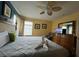 King-size bed in a bedroom with a ceiling fan and ensuite bathroom access at 2718 Lido Key Dr, Kissimmee, FL 34747