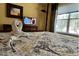 Main bedroom with a king-size bed, TV, and lots of natural light at 2718 Lido Key Dr, Kissimmee, FL 34747