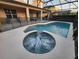 Relaxing pool and spa with safety fence and covered patio at 2718 Lido Key Dr, Kissimmee, FL 34747