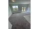 Spacious living room with carpet and sliding doors at 153 Mandovi St, Davenport, FL 33837