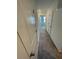 Hallway with neutral carpeting and access to bedrooms at 153 Mandovi St, Davenport, FL 33837