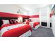 Mickey Mouse themed bedroom with two twin beds, nightstands, and red accents at 7554 Marker Ave, Kissimmee, FL 34747
