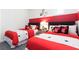 Mickey Mouse themed bedroom with two twin beds, nightstands, and red accents at 7554 Marker Ave, Kissimmee, FL 34747