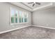 Spacious bedroom with plush carpeting and large window with shutters at 3951 Carrick Bend Dr, Kissimmee, FL 34746