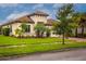 Single-story home with tile roof, landscaping, and paved driveway at 3951 Carrick Bend Dr, Kissimmee, FL 34746