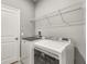 Laundry room with washer, dryer, and overhead shelving at 3951 Carrick Bend Dr, Kissimmee, FL 34746