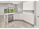 Kitchen island with white cabinets and stainless steel dishwasher at 3951 Carrick Bend Dr, Kissimmee, FL 34746