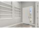 Bright foyer with neutral gray walls and built-in shelving at 3951 Carrick Bend Dr, Kissimmee, FL 34746