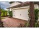 Attached garage with light beige door and brick paver driveway at 3951 Carrick Bend Dr, Kissimmee, FL 34746