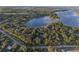 Aerial view of property showing home nestled amongst lush trees near a lake at 17577 Davenport Rd, Winter Garden, FL 34787