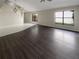 Open living room with dark laminate flooring and lots of natural light at 379 Cidermill Pl, Lake Mary, FL 32746