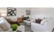 Living room with white sofas, coffee table, geometric rug, and wood cabinet at 3718 Bluethread Way, Poinciana, FL 34759