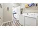 Laundry room with washer, dryer, and overhead shelving at 4782 Kings Castle Cir, Kissimmee, FL 34746