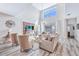 Bright living room featuring high ceilings, comfortable seating, and tile floors at 4782 Kings Castle Cir, Kissimmee, FL 34746
