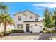 Two-story house with a white exterior and a two car garage at 4782 Kings Castle Cir, Kissimmee, FL 34746