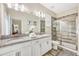 Double vanity bathroom with granite countertop, large shower, and tile flooring at 4782 Kings Castle Cir, Kissimmee, FL 34746