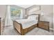 Bedroom with a wood bed frame, nightstand, and window with blinds at 4782 Kings Castle Cir, Kissimmee, FL 34746