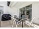 Covered patio with table, chairs, and grill at 4782 Kings Castle Cir, Kissimmee, FL 34746