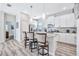 Well-equipped kitchen featuring white cabinets, granite island, and breakfast bar at 4782 Kings Castle Cir, Kissimmee, FL 34746