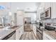 Modern kitchen with stainless steel appliances and granite countertops at 4782 Kings Castle Cir, Kissimmee, FL 34746