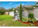 Mobile home's front entrance with gray porch and landscaping at 141 Autumn Ct, Saint Cloud, FL 34771