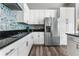 White cabinets and stainless steel appliances at 1407 Fairview Cir, Reunion, FL 34747