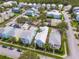 Aerial view of a house with a metal roof and pool in a residential neighborhood at 1407 Fairview Cir, Reunion, FL 34747