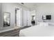 Main bedroom with king-size bed and view into bathroom and living area at 1407 Fairview Cir, Reunion, FL 34747