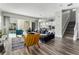 Open living area with gray wood floors and modern furniture at 1407 Fairview Cir, Reunion, FL 34747
