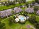 Aerial view of condos with a pool and surrounding landscape at 1407 Fairview Cir, Reunion, FL 34747