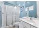 Clean bathroom with a walk-in shower and white vanity at 1407 Fairview Cir, Reunion, FL 34747