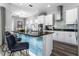 White kitchen cabinets, granite counters, and breakfast bar at 1407 Fairview Cir, Reunion, FL 34747