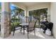 Covered patio with dining table and grill for outdoor entertaining at 1407 Fairview Cir, Reunion, FL 34747