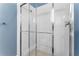 Clean shower with glass enclosure and white tile at 1407 Fairview Cir, Reunion, FL 34747